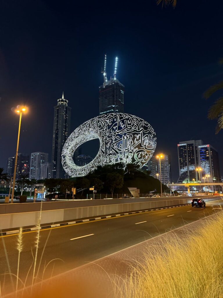 Stunning view of Dubai's illuminated Museum of the Future against a city skyline at night.